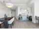 Open dining area has stylish storage, neutral walls, modern light fixture, and light wood floors at 2001 Lincoln St # 1822, Denver, CO 80202