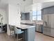 Modern kitchen with stainless steel appliances, island seating and light countertops with lots of natural light at 2001 Lincoln St # 1822, Denver, CO 80202