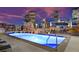 Rooftop pool in a city setting, lit with blue lights, offering lounge chairs and city views at 2001 Lincoln St # 1822, Denver, CO 80202