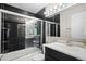 Modern bathroom with black tile and sleek fixtures offers a luxurious experience at 430 Chestnut Way, Broomfield, CO 80020