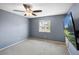 Bright bedroom with ceiling fan, window and mounted TV provides a cozy space at 430 Chestnut Way, Broomfield, CO 80020