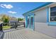 Relax on the spacious outdoor deck with grey wooden flooring and charming, light blue trim overlooking the neighborhood at 430 Chestnut Way, Broomfield, CO 80020