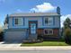 Charming two-story home features a well-maintained lawn, brick accents, and bright blue trim at 430 Chestnut Way, Broomfield, CO 80020