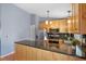 Modern kitchen features wood cabinetry, granite countertops, and stainless steel appliances at 430 Chestnut Way, Broomfield, CO 80020