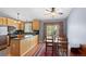 Bright kitchen with wood cabinets, granite countertops, and a dining area with natural light at 430 Chestnut Way, Broomfield, CO 80020