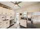 Bright kitchen features stainless steel appliances, white cabinets, and subway tile backsplash at 3384 W 29Th Ave, Denver, CO 80211