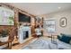 Stylish living room boasts exposed brick, a fireplace, and an open floor plan at 3384 W 29Th Ave, Denver, CO 80211