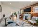 Stylish living room boasts exposed brick, a fireplace, and an open floor plan at 3384 W 29Th Ave, Denver, CO 80211