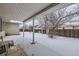 Covered patio overlooking a snowy backyard at 646 N 13Th Ave, Brighton, CO 80601