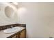 Powder room with a pedestal sink and decorative mirror at 646 N 13Th Ave, Brighton, CO 80601