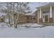 Brick home's front entrance with snowy landscaping at 646 N 13Th Ave, Brighton, CO 80601