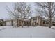 Brick home with a covered entryway and a snowy front yard at 646 N 13Th Ave, Brighton, CO 80601