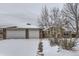 Brick house with a two-car garage and a partially snow covered front yard at 646 N 13Th Ave, Brighton, CO 80601