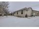 Back of house with snowy yard and trees at 646 N 13Th Ave, Brighton, CO 80601