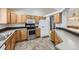 Kitchen with oak cabinets, stainless steel appliances and tile floor at 646 N 13Th Ave, Brighton, CO 80601