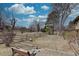 Scenic backyard featuring a rustic wooden fence and mature trees, ideal for peaceful outdoor recreation at 7690 S Uinta Ct, Centennial, CO 80112
