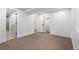 Neutral carpeted basement features white walls and trim and multiple closets and doorways at 13416 W 22Nd Pl, Golden, CO 80401