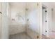 Bright glass-enclosed shower with tiled walls, bronze fixtures, and a convenient shelf insert at 13416 W 22Nd Pl, Golden, CO 80401