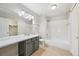 Bright bathroom features a large mirror, vanity with storage, and a shower-tub combo at 1259 W 112Th Ave # B, Denver, CO 80234