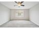 Neutral bedroom with a ceiling fan and a large window at 1259 W 112Th Ave # B, Denver, CO 80234