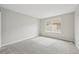 The bedroom features a large window and neutral carpeting at 1259 W 112Th Ave # B, Denver, CO 80234