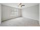 Bedroom features a ceiling fan and large window for natural light at 1259 W 112Th Ave # B, Denver, CO 80234