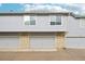 A gray two-story condo with a garage, brick accents, and a well-maintained exterior at 1259 W 112Th Ave # B, Denver, CO 80234