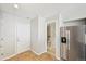 Bright kitchen area with tile floors and stainless steel appliances; note the entry to the bathroom at 1259 W 112Th Ave # B, Denver, CO 80234