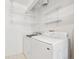 The laundry room features a washer, dryer, and shelving for convenient storage at 1259 W 112Th Ave # B, Denver, CO 80234
