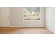 Bright living room with hardwood floors and a large window offering a view of the outside, creating an inviting space at 1259 W 112Th Ave # B, Denver, CO 80234