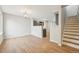 Open-concept living room with hardwood floors, neutral walls, and stylish light fixtures at 1259 W 112Th Ave # B, Denver, CO 80234