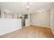 Open-concept living room featuring modern lighting and views of the updated kitchen area at 1259 W 112Th Ave # B, Denver, CO 80234