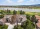 Aerial view featuring a home next to a large pond and golf course, with mountain views at 7400 W Grant Ranch Blvd # 5, Littleton, CO 80123