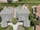 An aerial view shows the backyard deck, manicured lawn, and community layout of this property at 7400 W Grant Ranch Blvd # 5, Littleton, CO 80123