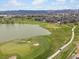 Aerial view of a golf course with a lake and a golf cart on a winding path at 7400 W Grant Ranch Blvd # 5, Littleton, CO 80123