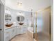 Light and airy bathroom featuring double sinks, a soaking tub, and a glass-enclosed shower at 7400 W Grant Ranch Blvd # 5, Littleton, CO 80123