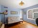 Cozy bedroom with hardwood floors, a comfortable sofa, and a window that provides great natural lighting at 7400 W Grant Ranch Blvd # 5, Littleton, CO 80123