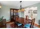 The dining room features a wooden table and chairs under a decorative light fixture at 7400 W Grant Ranch Blvd # 5, Littleton, CO 80123