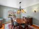 Traditional dining room with a wood table, decorative chandelier, and a large window at 7400 W Grant Ranch Blvd # 5, Littleton, CO 80123