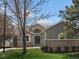 Charming single-Gathering home featuring stone and vinyl siding, manicured lawn, and mature trees at 7400 W Grant Ranch Blvd # 5, Littleton, CO 80123
