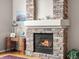 Cozy living room featuring a stone fireplace with a white mantle and a decorative desk at 7400 W Grant Ranch Blvd # 5, Littleton, CO 80123