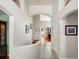 Bright foyer with tile and wood floors, features art niches, an open staircase, and views into the living area at 7400 W Grant Ranch Blvd # 5, Littleton, CO 80123
