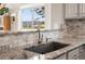 Granite countertops and a modern sink enhance this well-lit kitchen with beautiful outdoors views at 7400 W Grant Ranch Blvd # 5, Littleton, CO 80123