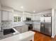Modern kitchen with granite countertops, stainless steel appliances, and white cabinetry offering a clean and elegant design at 7400 W Grant Ranch Blvd # 5, Littleton, CO 80123
