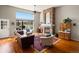 Spacious living room featuring large windows with scenic views, a stone fireplace, and comfortable seating at 7400 W Grant Ranch Blvd # 5, Littleton, CO 80123