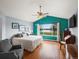 Bright main bedroom with hardwood floors, lake views, and a cozy seating area at 7400 W Grant Ranch Blvd # 5, Littleton, CO 80123
