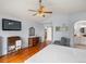 Spacious main bedroom with hardwood floors, neutral walls, and a decorative ceiling fan at 7400 W Grant Ranch Blvd # 5, Littleton, CO 80123