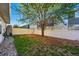 Fully fenced backyard with a mix of lawn and stone, providing a secure outdoor space at 4705 Andes St, Denver, CO 80249