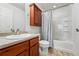 Standard bathroom with a shower-tub combo and wooden vanity at 4705 Andes St, Denver, CO 80249