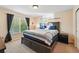 Comfortable bedroom with a large window, plush bedding, and warm, inviting decor at 4705 Andes St, Denver, CO 80249